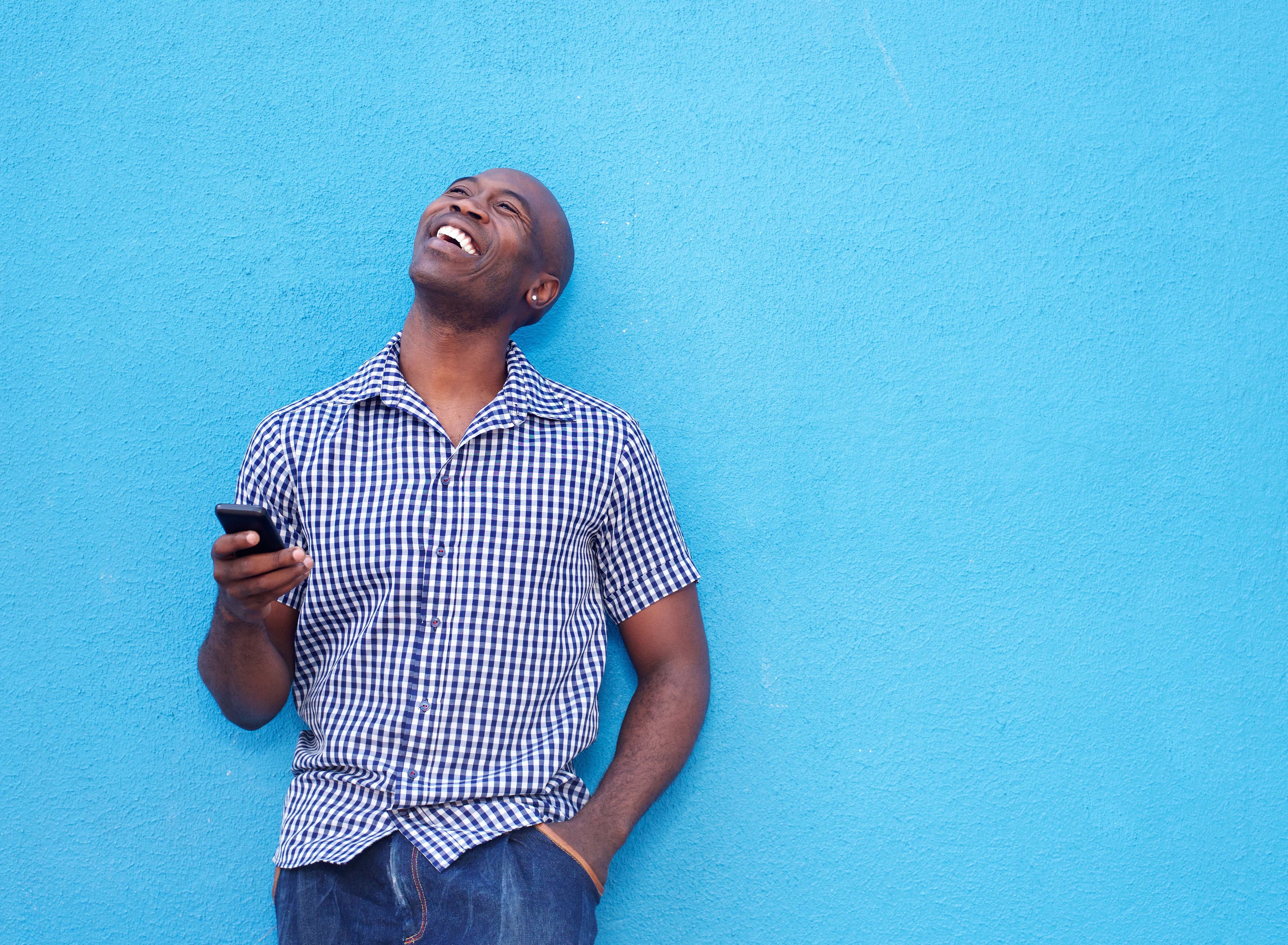 Smiling african man with mobile phone